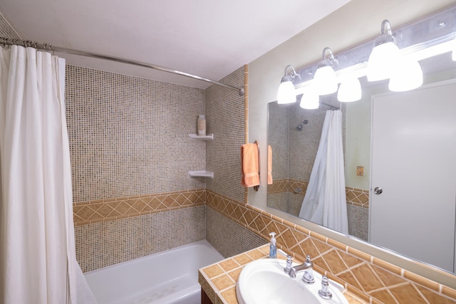 bathroom with backsplash, vanity, and shower / bathtub combination with curtain