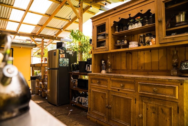 bar featuring wood walls, vaulted ceiling with beams, stainless steel fridge, and dark hardwood / wood-style flooring