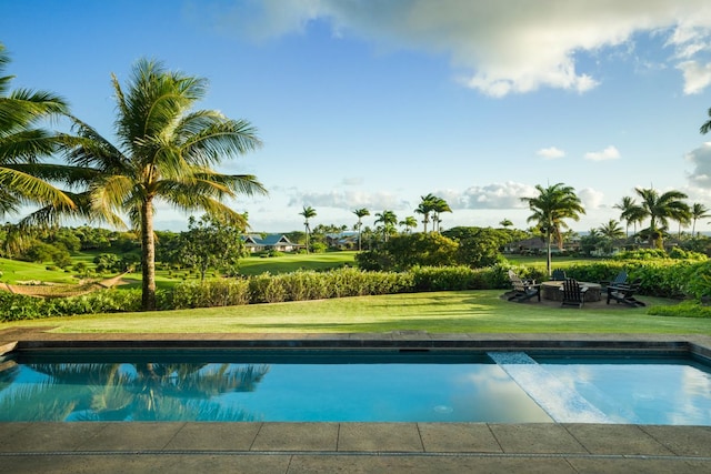 view of swimming pool with a lawn