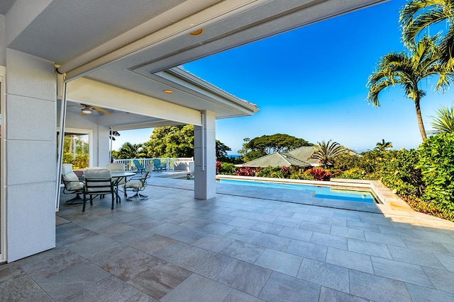 view of swimming pool featuring ceiling fan and a patio