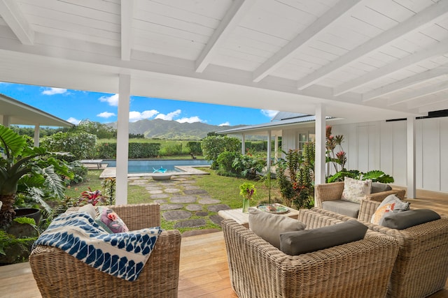 exterior space with a mountain view and beam ceiling