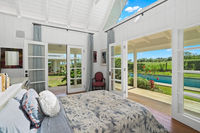 bedroom with beam ceiling, wood walls, high vaulted ceiling, and wood-type flooring