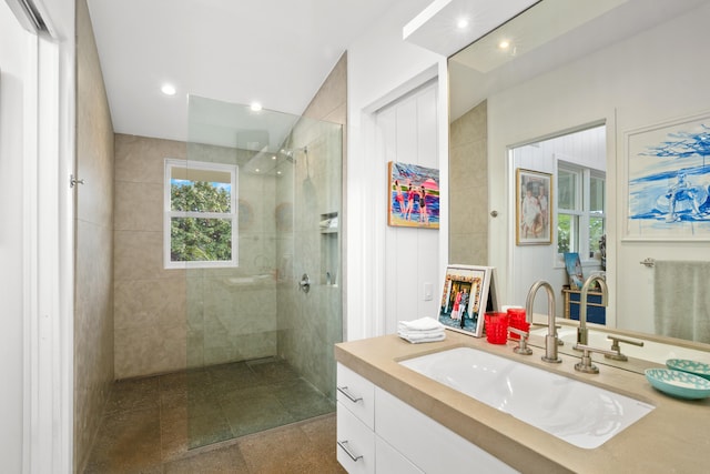 bathroom featuring vanity and tiled shower