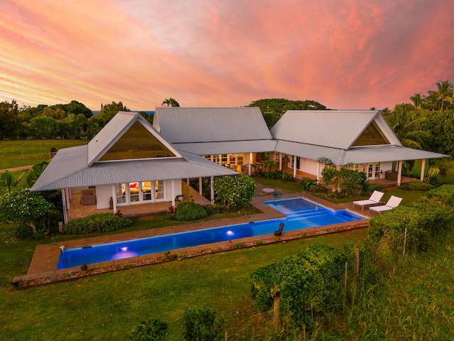 pool at dusk with a yard