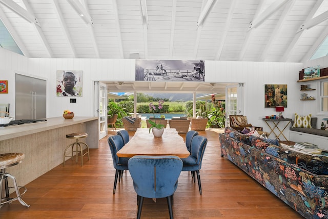 dining area with vaulted ceiling with beams, wood-type flooring, and wood ceiling