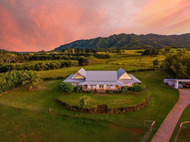 aerial view at dusk featuring a mountain view