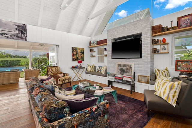 living room with beamed ceiling, wood-type flooring, high vaulted ceiling, and wood ceiling