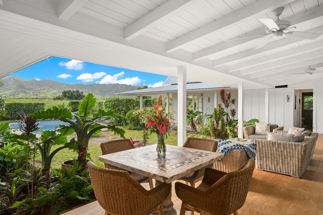 view of patio with outdoor lounge area, a mountain view, and ceiling fan