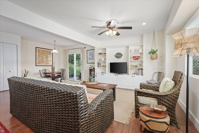 living room with dark hardwood / wood-style floors and ceiling fan