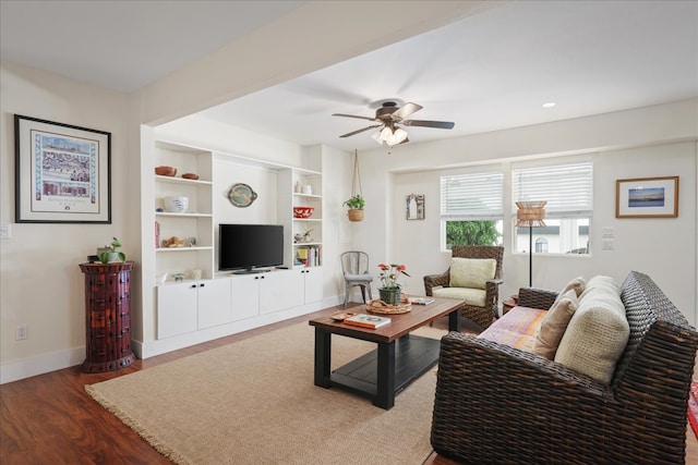 living room with hardwood / wood-style floors and ceiling fan