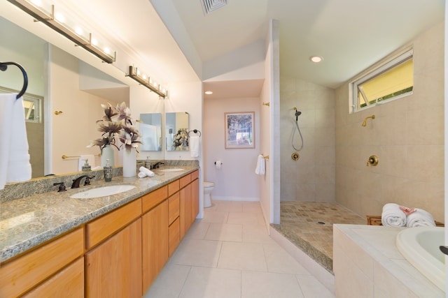 full bathroom with plus walk in shower, tile patterned flooring, vaulted ceiling, toilet, and vanity