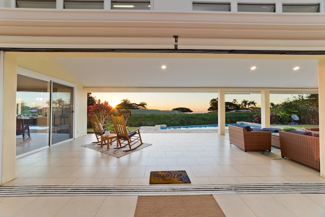 patio terrace at dusk featuring an outdoor living space