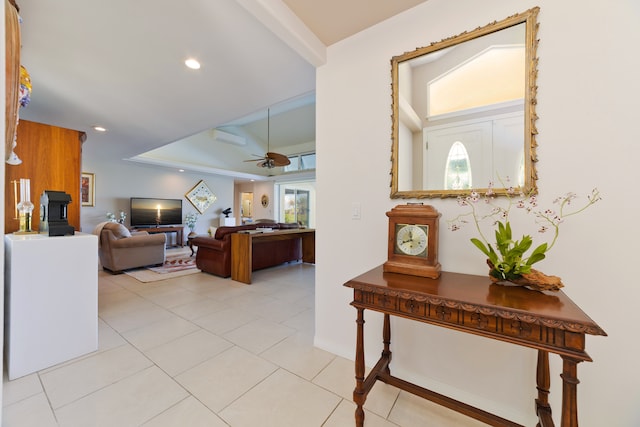 living room with a wall unit AC, ceiling fan, and light tile patterned flooring