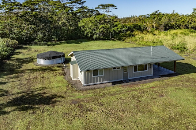 farmhouse with a pool and a front lawn