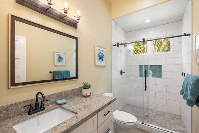 bathroom with vanity, toilet, and an enclosed shower