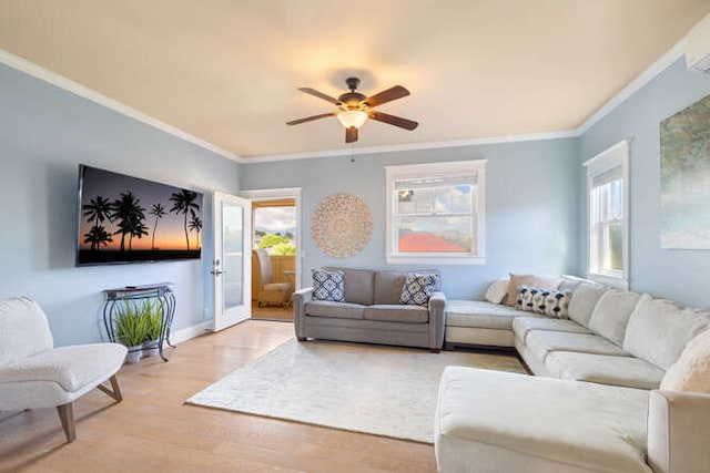 living room with hardwood / wood-style floors, plenty of natural light, and ornamental molding