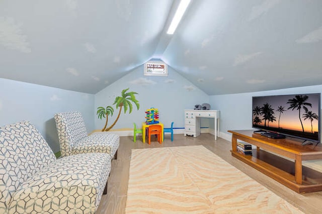 playroom featuring light hardwood / wood-style floors and vaulted ceiling