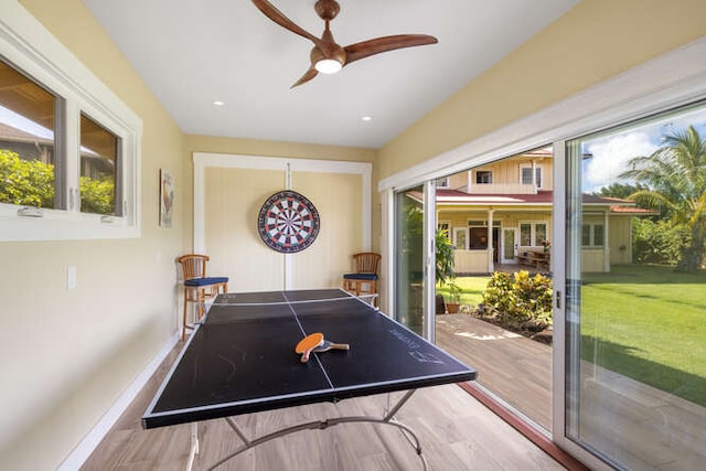 playroom with ceiling fan and light hardwood / wood-style floors