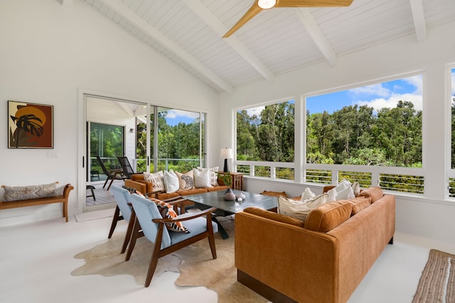 sunroom with vaulted ceiling with beams, ceiling fan, and wood ceiling