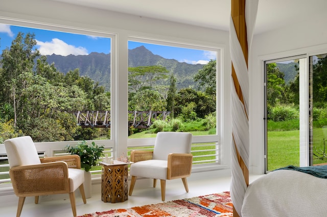 sunroom featuring a mountain view and a healthy amount of sunlight