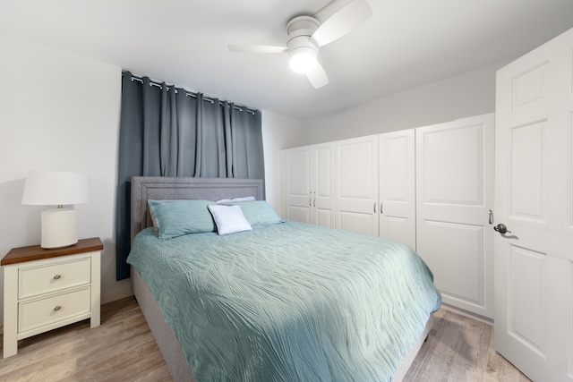 bedroom featuring ceiling fan, a closet, and light hardwood / wood-style flooring