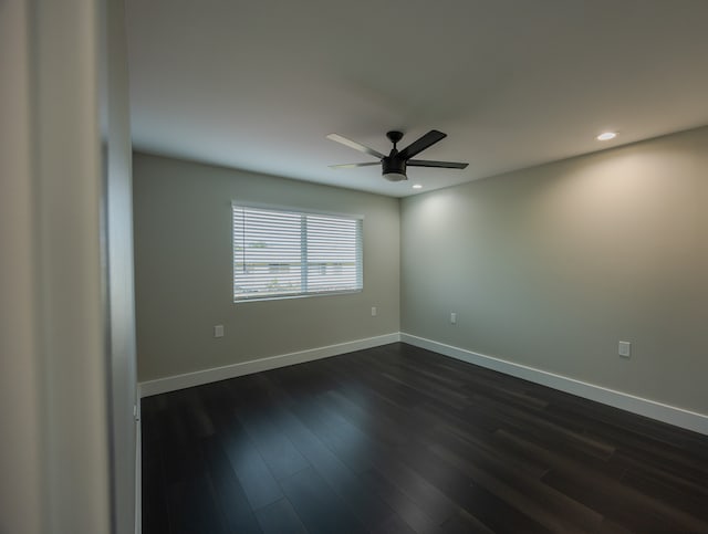 empty room with dark hardwood / wood-style floors and ceiling fan