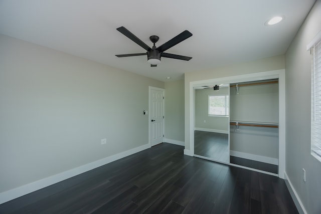 unfurnished bedroom featuring dark hardwood / wood-style floors, a closet, and ceiling fan