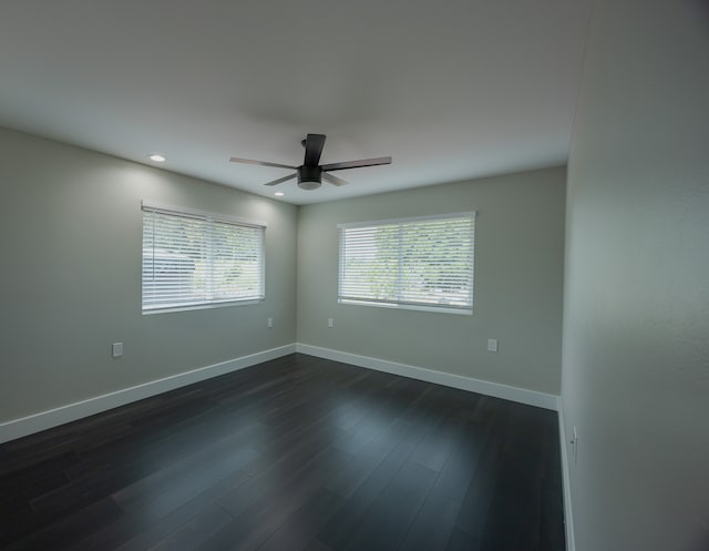 unfurnished room featuring dark hardwood / wood-style floors and ceiling fan