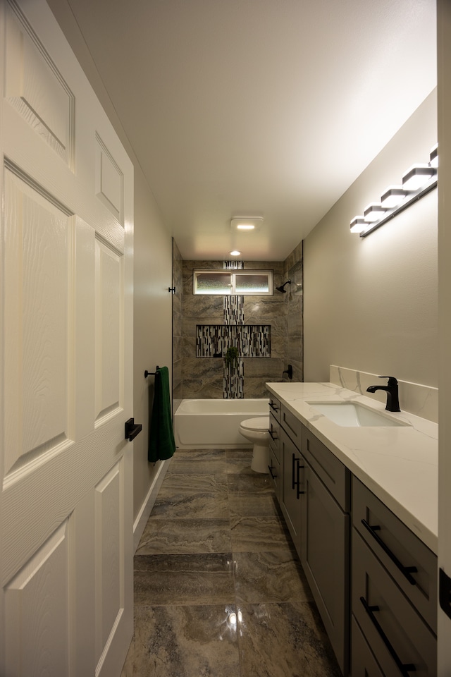 full bathroom with hardwood / wood-style floors, vanity, tiled shower / bath combo, and toilet