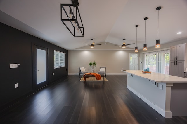 kitchen featuring white cabinetry, ceiling fan, hanging light fixtures, dark hardwood / wood-style flooring, and vaulted ceiling