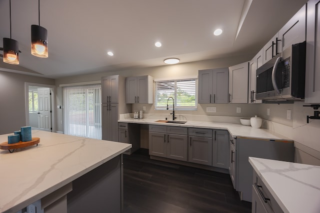 kitchen with gray cabinets, dark hardwood / wood-style flooring, and sink