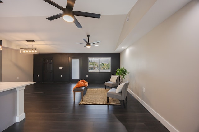 sitting room featuring dark hardwood / wood-style flooring and ceiling fan with notable chandelier