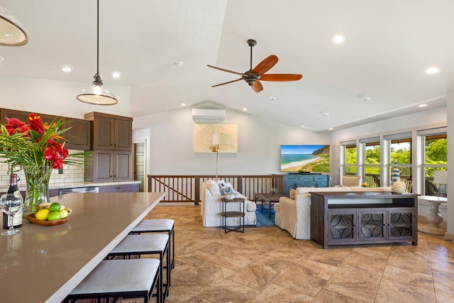 living room featuring ceiling fan, an AC wall unit, and vaulted ceiling