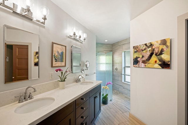 bathroom featuring a tile shower and vanity