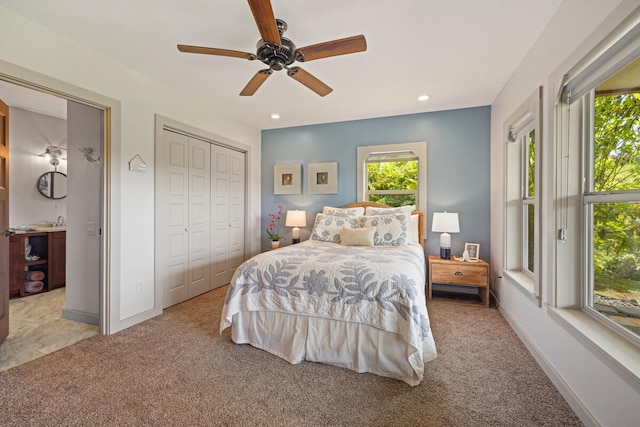 bedroom featuring ceiling fan, a closet, and light colored carpet