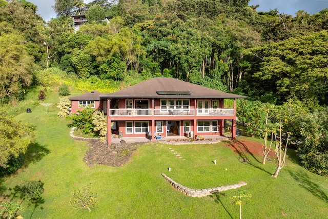 rear view of house featuring a lawn, a patio, and a wooden deck