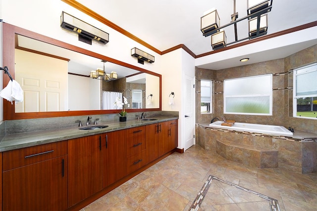 bathroom with tiled bath, vanity, a chandelier, and ornamental molding