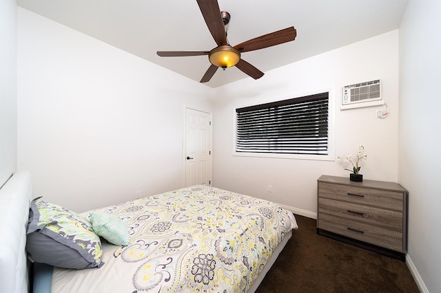 bedroom with dark carpet, a wall unit AC, and ceiling fan