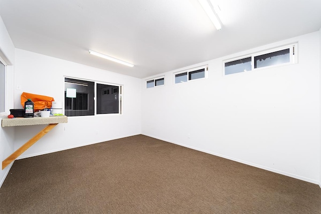 basement featuring dark colored carpet