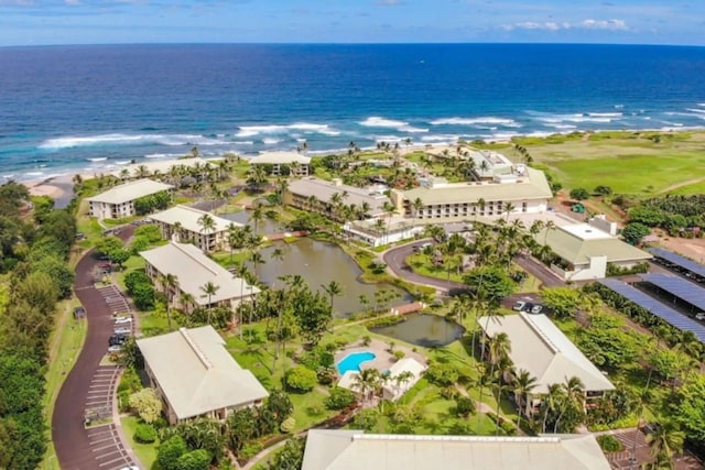 birds eye view of property with a water view and a view of the beach