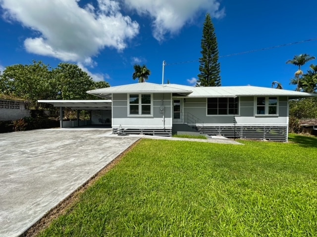 view of front of home with a carport and a front yard