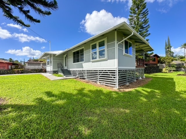 back of property featuring a lawn