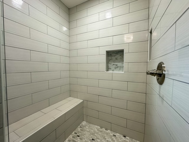 bathroom with a tile shower