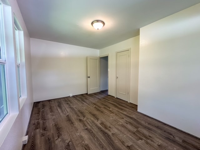 spare room with dark wood-type flooring