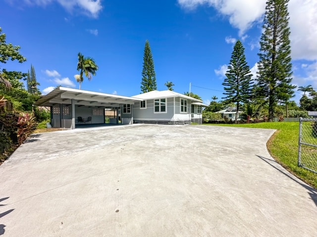 view of front of home with a front yard and a carport