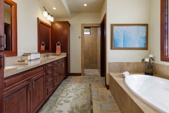 bathroom featuring shower with separate bathtub and vanity