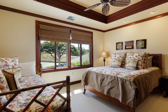 carpeted bedroom featuring ceiling fan and ornamental molding