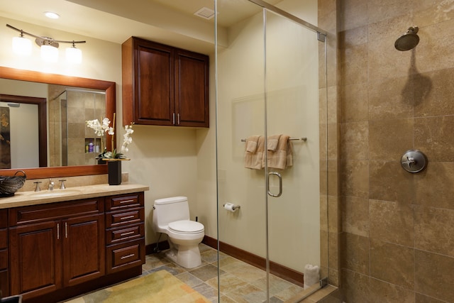 bathroom with tile patterned flooring, vanity, toilet, and a shower with shower door