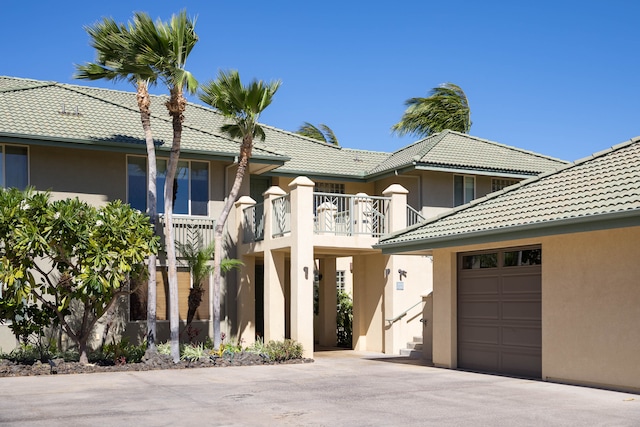 view of front facade featuring a balcony and a garage