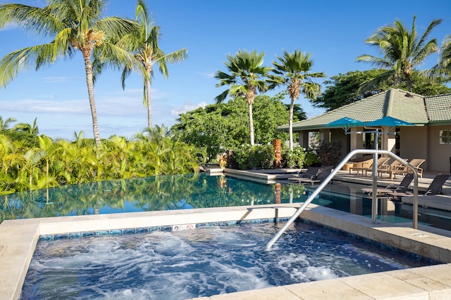 view of swimming pool with a water view and a patio area